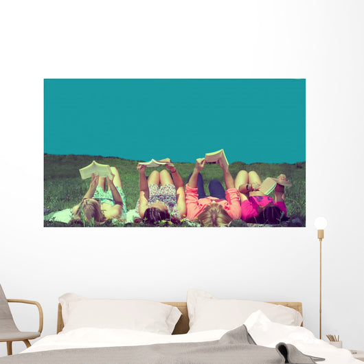 friends reading under sunshine lying on the meadow Wall Mural