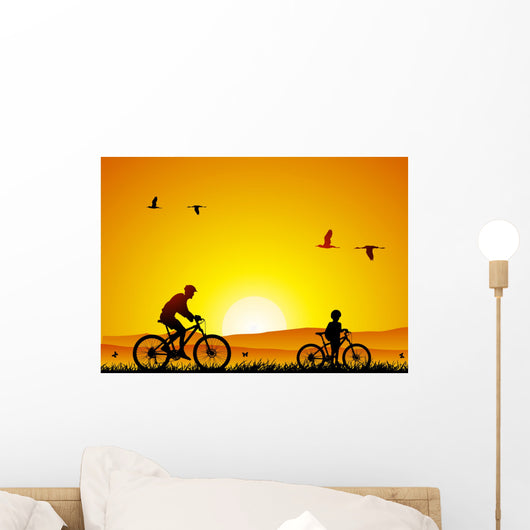 Mountain bike at sunset with child Wall Mural