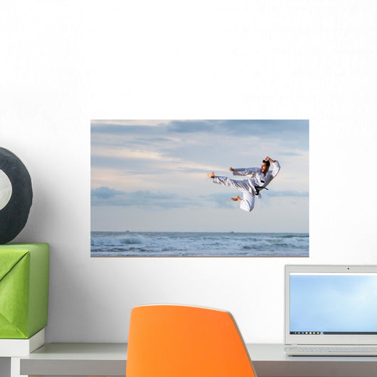 Man jumping to practice Marcial Arts kick Wall Mural