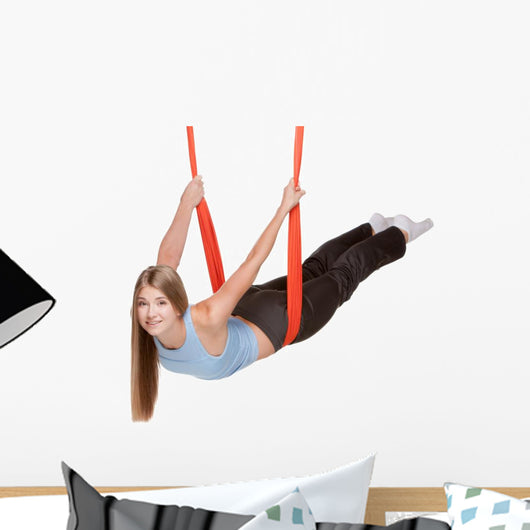 Young woman doing aerial yoga Wall Decal