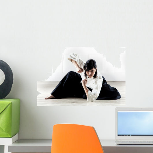 beautiful woman wearing a hakama practicing Aikido Wall Mural