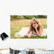 Romantic girl writing in a diary lying down outdoors Wall Mural