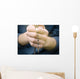 man prays with a rosary in hands Wall Decal