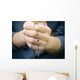 man prays with a rosary in hands Wall Decal