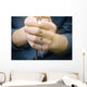 man prays with a rosary in hands Wall Decal
