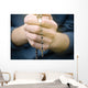 man prays with a rosary in hands Wall Decal