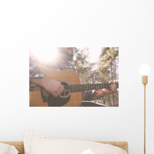 A folk country musician playing his guitar. Wall Decal