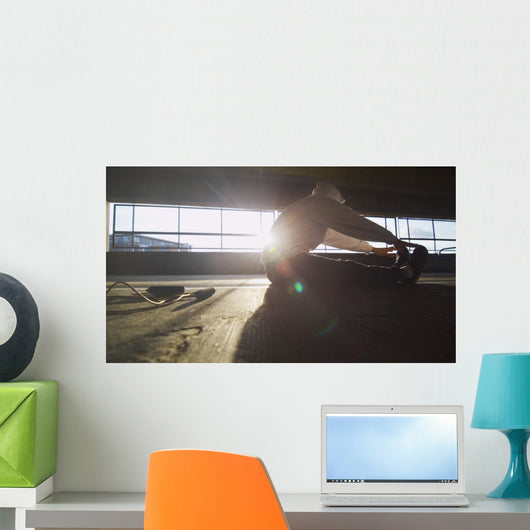 Hooded athlete stretching before or after a workout Wall Decal