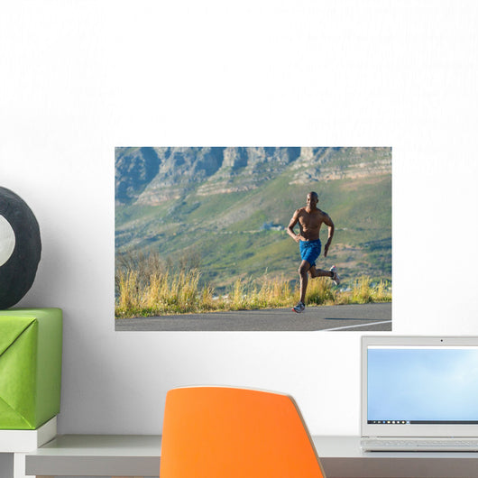 Athletic, black male running along a road Wall Decal