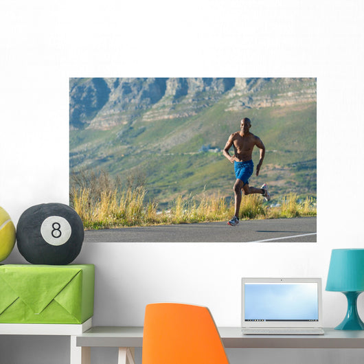 Athletic,  black male running along a road Wall Decal