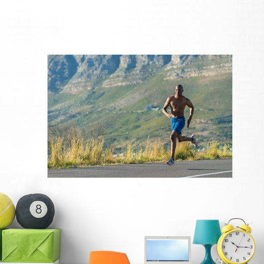 Athletic,  black male running along a road Wall Decal