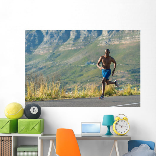 Athletic,  black male running along a road Wall Decal