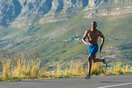 Athletic,  black male running along a road Wall Decal
