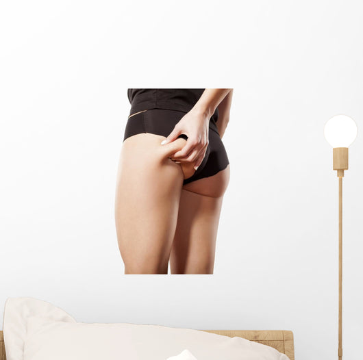 woman checking her bottom with pinching Wall Decal