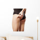 woman checking her bottom with pinching Wall Decal