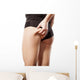 woman checking her bottom with pinching Wall Decal