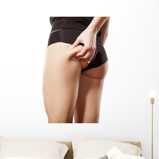 woman checking her bottom with pinching Wall Decal