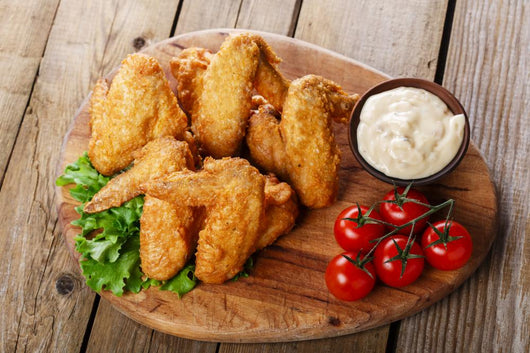 Fried chicken wings with sauce and tomatoes Wall Decal