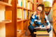 Woman student in college library Wall Decal