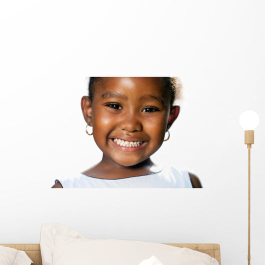 Extreme close up of small african girl showing teeth.T Wall Decal