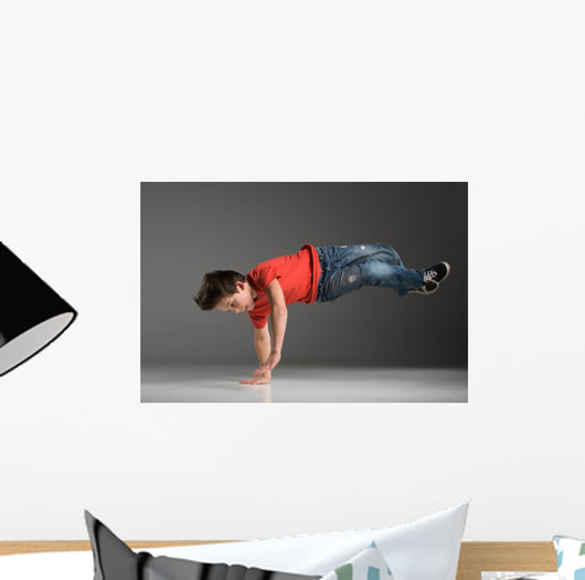 little break dancer showing his skills on grey background. Wall Decal