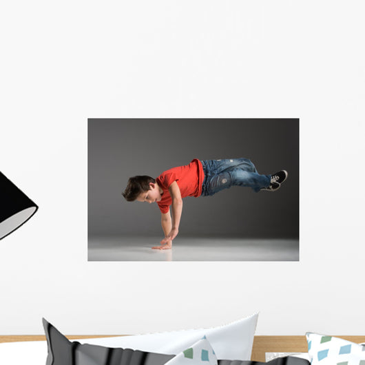 little break dancer showing his skills on grey background. Wall Decal