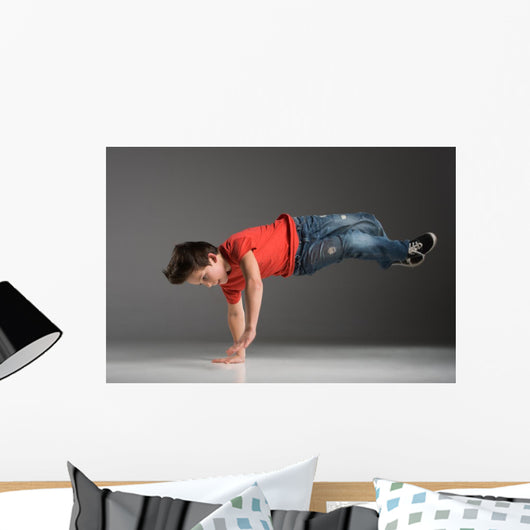 little break dancer showing his skills on grey background. Wall Decal