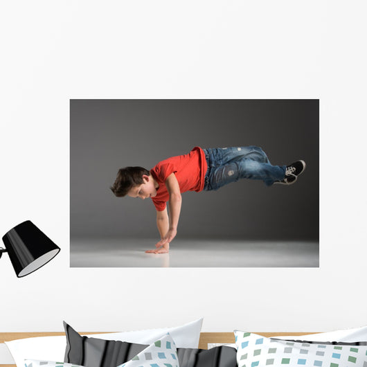 little break dancer showing his skills on grey background. Wall Decal