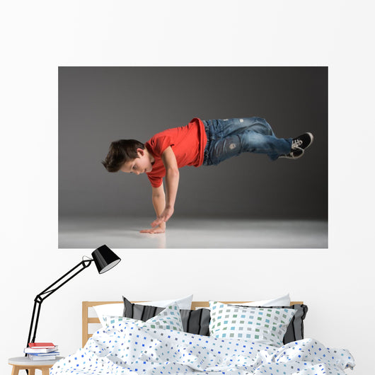 little break dancer showing his skills on grey background. Wall Decal