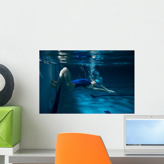 Female swimmer at the swimming pool.Underwater photo. Wall Decal