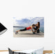 Young woman doing push-ups on a medicine ball with a coach Wall Decal
