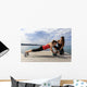 Young woman doing push-ups on a medicine ball with a coach Wall Decal