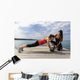 Young woman doing push-ups on a medicine ball with a coach Wall Decal