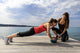 Young woman doing push-ups on a medicine ball with a coach Wall Decal