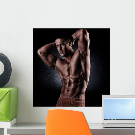a young and fit male model posing his muscles Wall Decal
