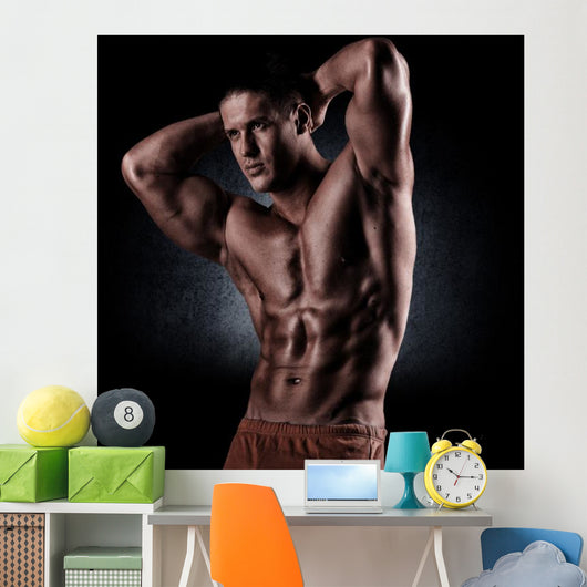 a young and fit male model posing his muscles Wall Decal