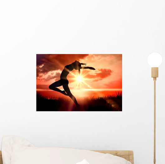 Composite image of side view of a sporty young woman stretching Wall Decal
