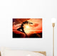 Composite image of side view of a sporty young woman stretching Wall Decal