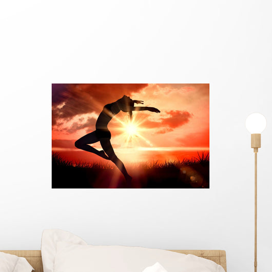 Composite image of side view of a sporty young woman stretching Wall Decal