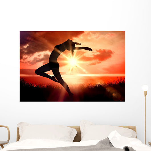 Composite image of side view of a sporty young woman stretching Wall Decal