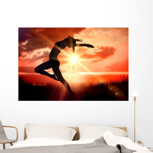 Composite image of side view of a sporty young woman stretching Wall Decal