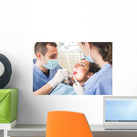 Dentist and Dental Assistant examining Patient teeth. Wall Decal