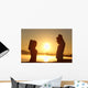 Silhouette of a fitness couple stretching at sunrise Wall Decal