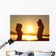 Silhouette of a fitness couple stretching at sunrise Wall Decal