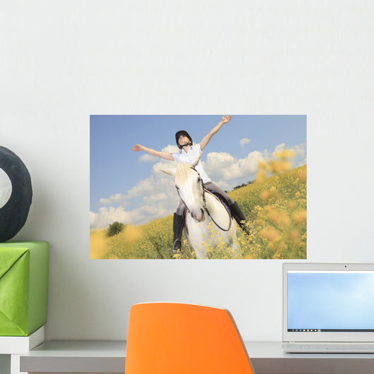 A white horse on yellow flower field with a rider. Wall Decal