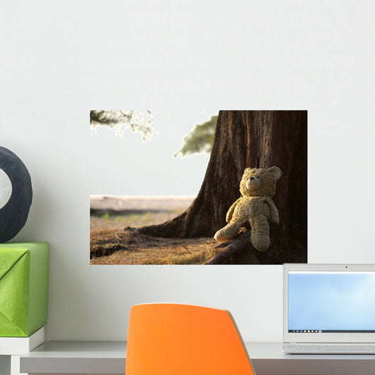teddy bear sitting against a tree Wall Decal