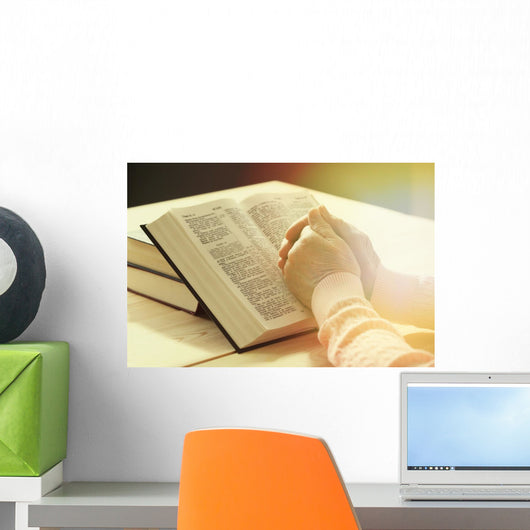 Hands of old woman with Bible on table Wall Mural