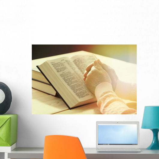 Hands of old woman with Bible on table Wall Mural