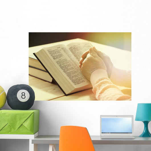 Hands of old woman with Bible on table Wall Mural