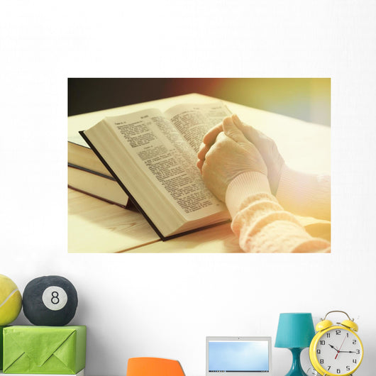 Hands of old woman with Bible on table Wall Mural